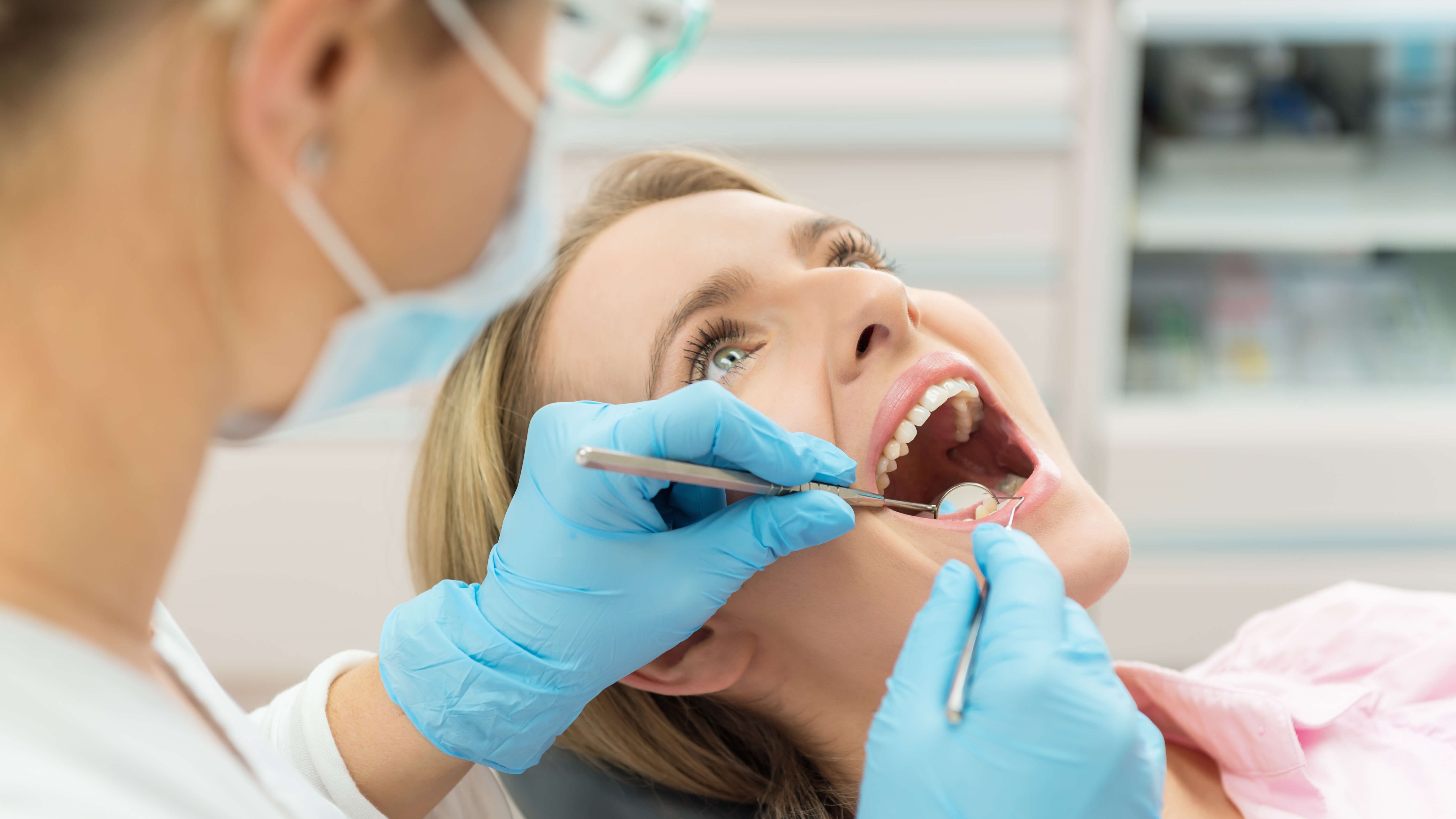 dentist looking in woman's mou